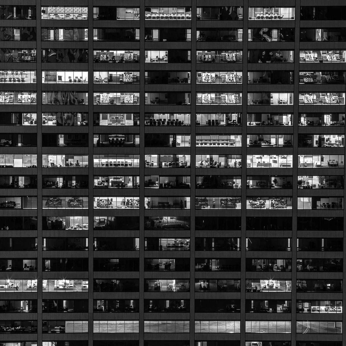 Lit office windows across a building at night