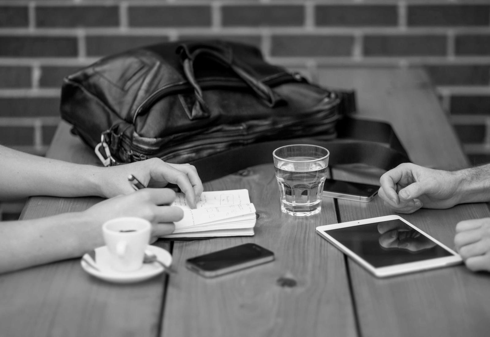 Two people working through notes at a shared table